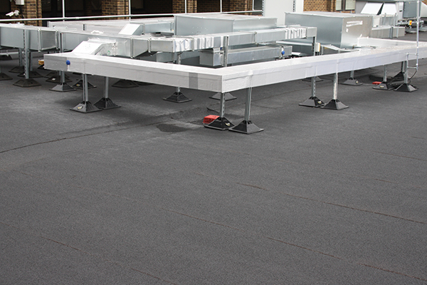 Felt roofing South East – flat roof installation with torch-on felt system and rooftop plant supports