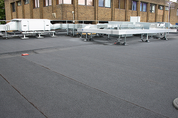 Felt roofing South East – flat roof installation with torch-on felt system and rooftop plant supports