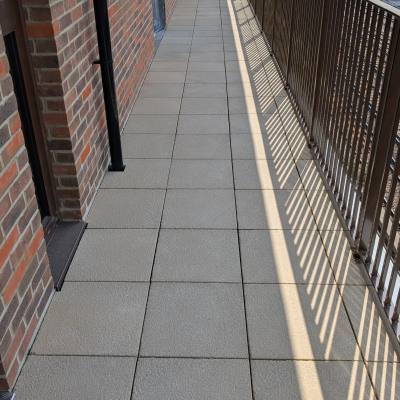 Hot Melt Roofing South East – close-up of roof walkway tiles over hot melt system on residential podium deck