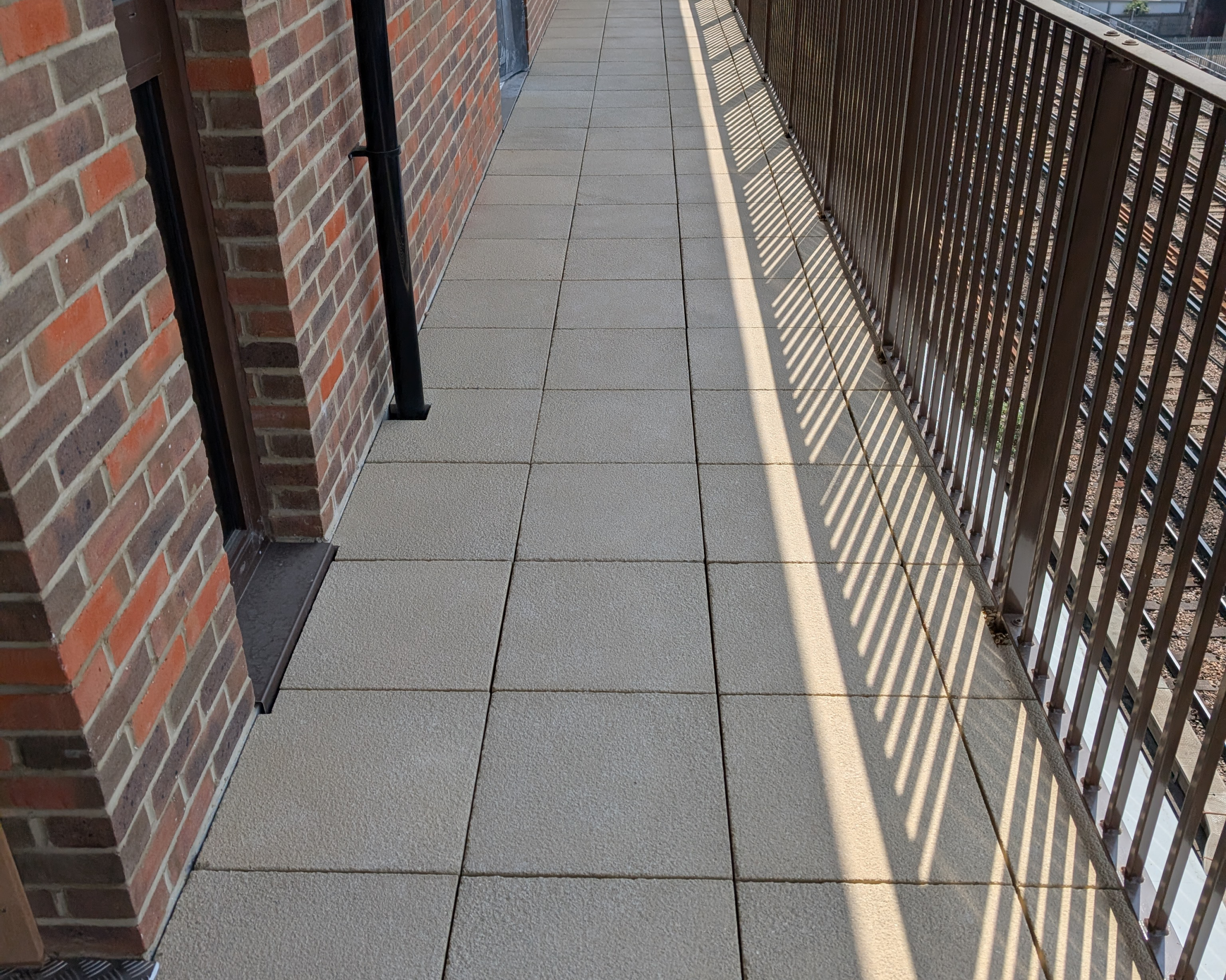 Hot Melt Roofing South East – close-up of roof walkway tiles over hot melt system on residential podium deck