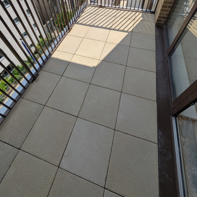 Hot Melt Roofing South East – paved rooftop walkway area with slab tiles over waterproofing system