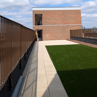 Hot Melt Roofing South East – finished rooftop terrace with artificial grass and paved walkway over hot melt waterproofing system