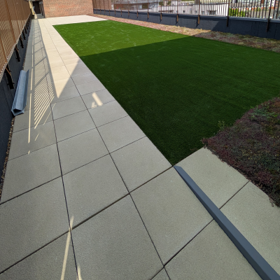 Hot Melt Roofing South East – combination of artificial grass and paving slabs on rooftop terrace