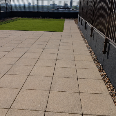 Hot Melt Roofing South East – large rooftop space with green surface and paved access path
