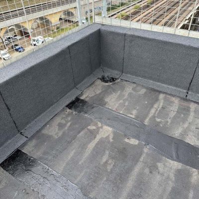 Hot Melt Roofing South East – corner section of hot melt waterproofing system with base layer and upstand detailing