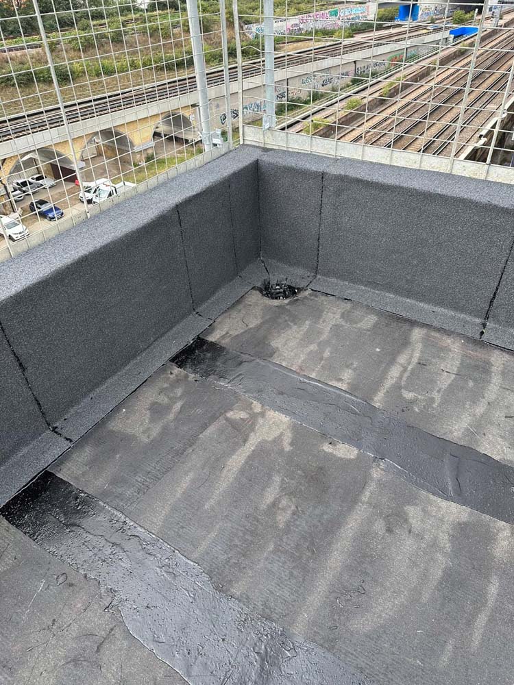 Hot Melt Roofing South East – corner section of hot melt waterproofing system with base layer and upstand detailing