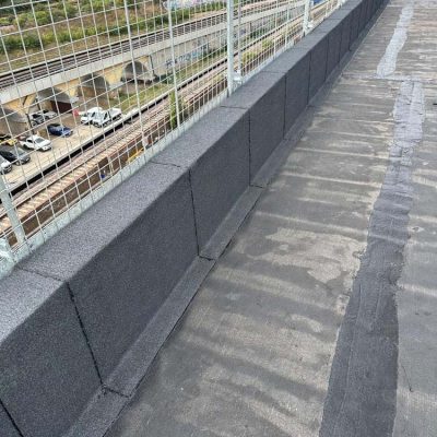 Hot Melt Roofing South East – long parapet edge section with completed hot melt waterproofing on high-rise building