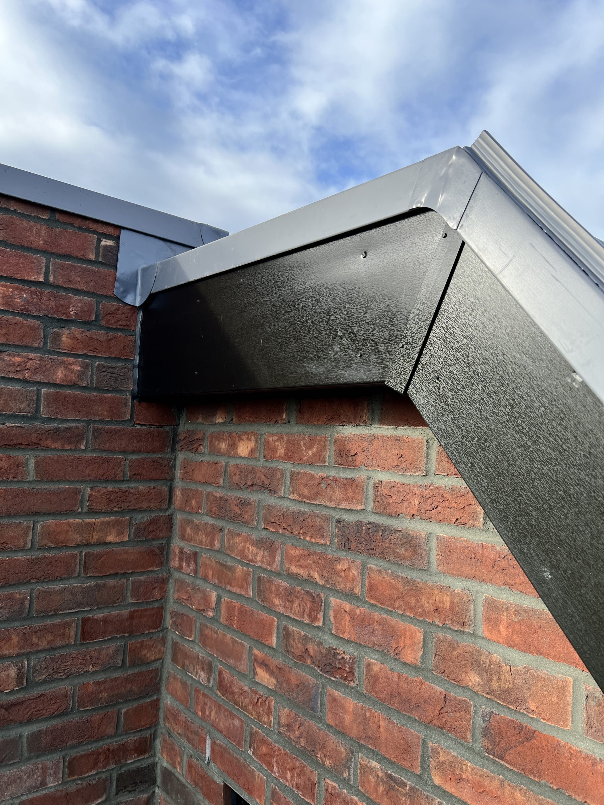 Close-up of parapet corner detailing on single ply roofing system with custom trim finish