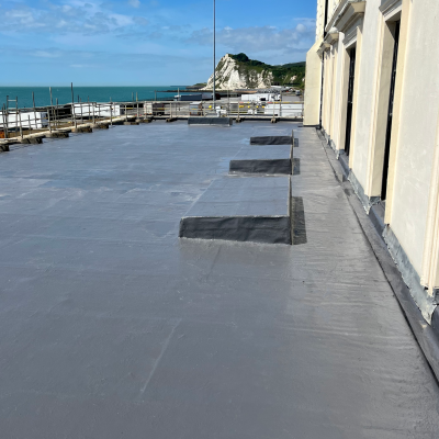 A flat roof covered with a liquid roofing system using the SIGnature Ultra Protect PU product. The flat roof over looks the White Cliffs of Dover and the Dover Port. AJ Lucas Roofing Contractors Serving Kent, London & South East