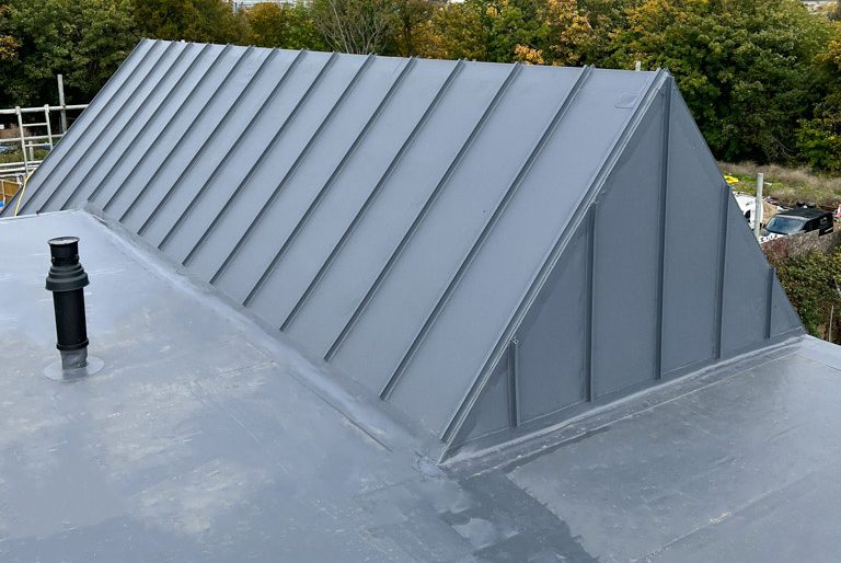 Flat and pitched roof fitted with IKO Armourplan single ply membrane by A J Lucas Roofing Contractors Serving Kent, London & South East